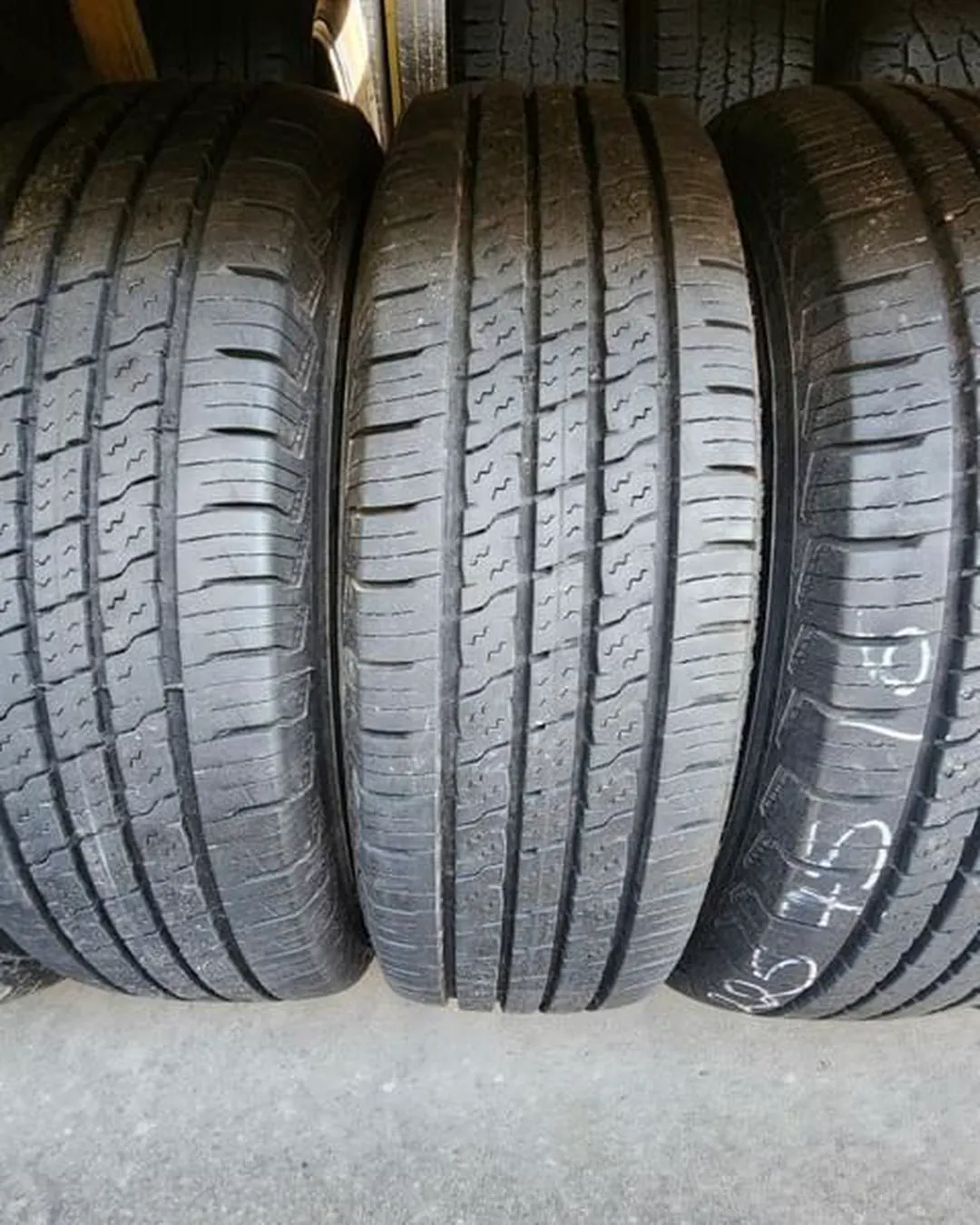 Three tires standing upright with tread patterns visible