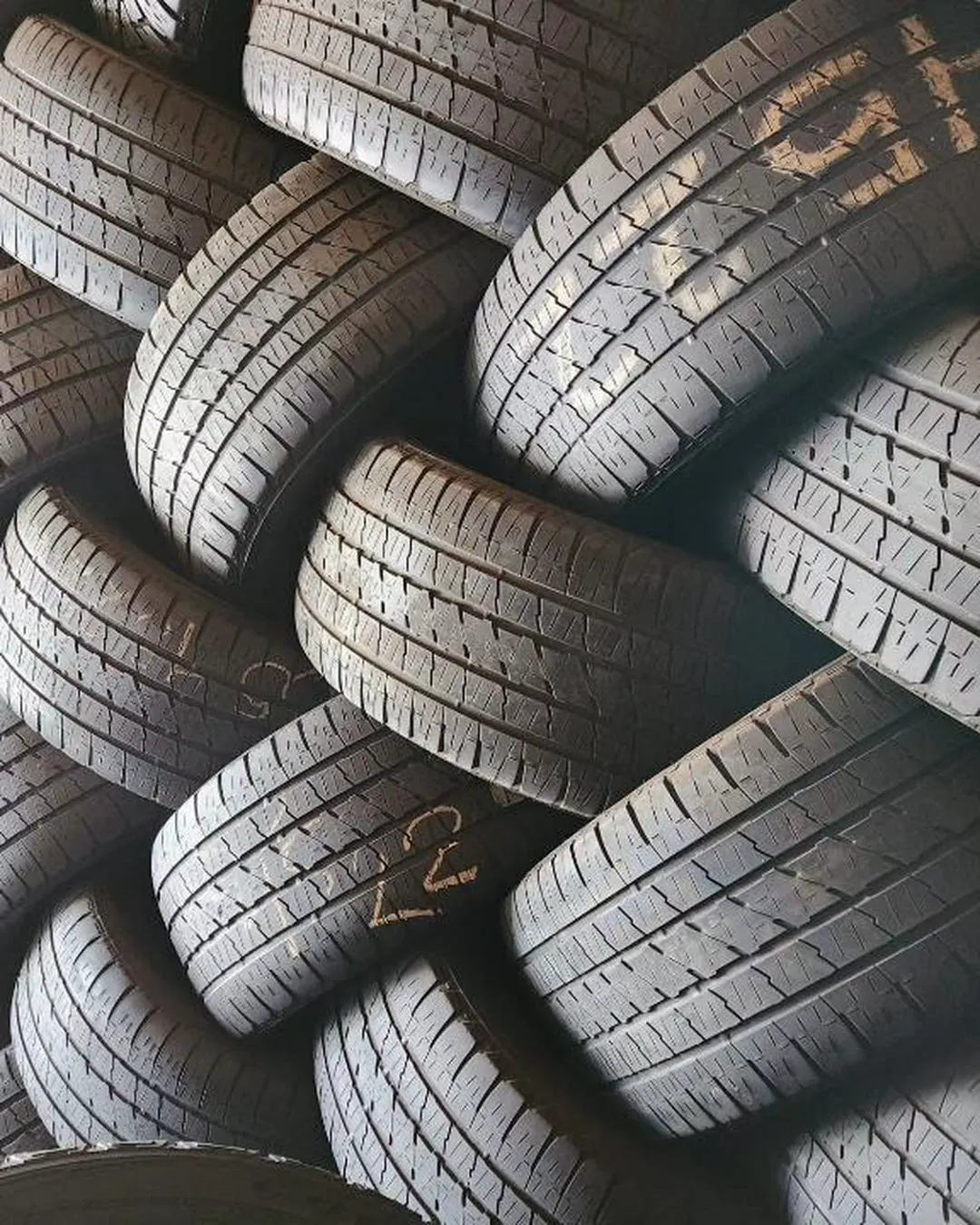 Dense wall of used tires stacked high